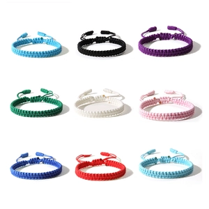 Detail of colorful hand-woven bracelets with adjustable sliding knots in nine colors