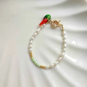 Close-up of glacier blue cat-eye stone beads and heart pendant with gold OT clasp