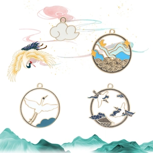 Detail view of Chinese style enamel rabbit pendants with crane and mountain motifs