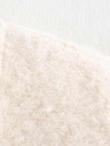 Close-up of premium cream faux fur material on the knit cardigan for women