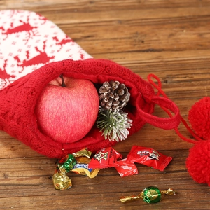 Classic red and white knitted Christmas stocking with reindeer patterns and pom-poms