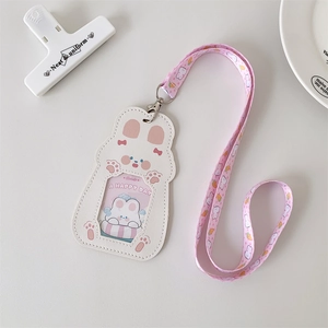 Detail of pink cartoon rabbit PU card holder with floral lanyard on white background