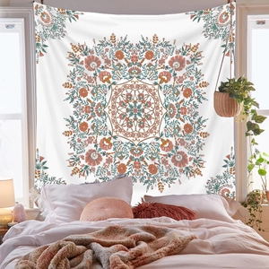 Detail of floral tapestry featuring pink and green patterns on a white background cloth