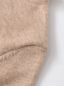 Detail of the soft knit fabric and shoulder seam on this beige cashmere blend top