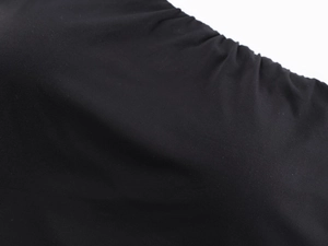 Macro detail of black high-elastic knit fabric showing fine texture and ruched design