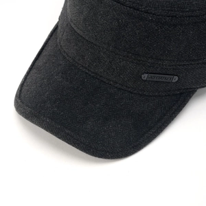 Close-up detail of a men's winter wool cap featuring a premium embossed rectangular label