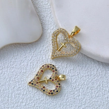 Detail of 18K gold heart pendants with cross inlay and multicolor zircon crystals