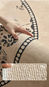 Close-up of thick textured beige rug with black dots showing soft woven surface quality