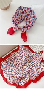 Detailed macro view of floral cotton linen scarf with red scalloped hem and vintage print