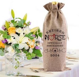 Linen wine gift bag for retired nurse on decorated table with flowers and glass