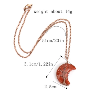 Detailed view of handmade copper wire tree of life on red jasper moon stone pendant