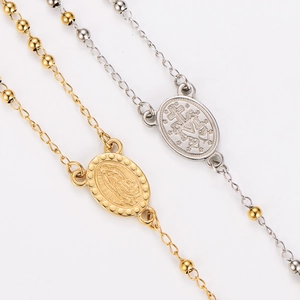 Gold and silver religious oval coin charm bracelets with metal beads on white background