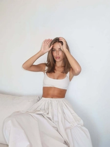Close-up of cream two-piece set featuring square neck crop top and pleated maxi skirt