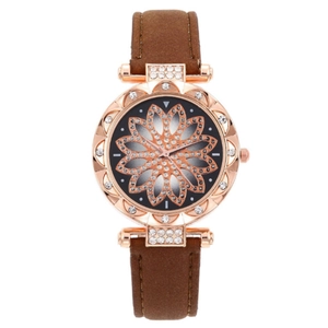 Detail of rose gold barrel watch with crystal bezel and brown matte leather strap
