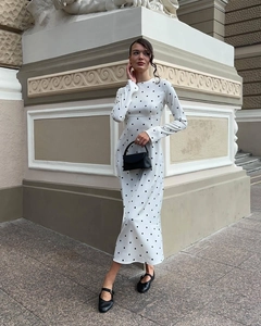 Detailed view of the round neckline and polka dot pattern on the long sleeve dress