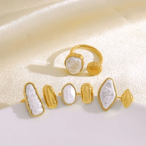 Elegant gold irregular ring with baroque pearl inlay on white silk background