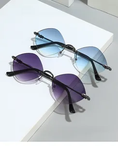 Detailed view of rimless diamond-cut lenses with gradient tint and ornate metal carvings