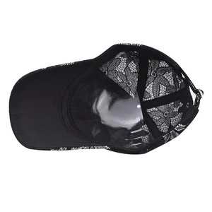 Detailed view of black floral lace baseball cap showing texture and metal buckle adjustment