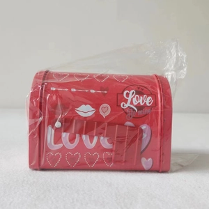 Close-up of a red tinplate mailbox gift box featuring Valentine heart and love motifs