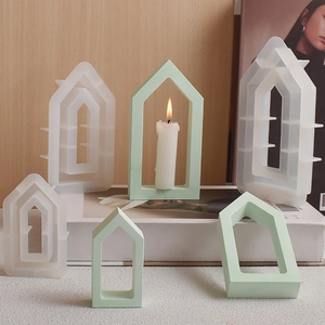 Three sizes of hollow house-shaped silicone molds with mint green plaster finished products