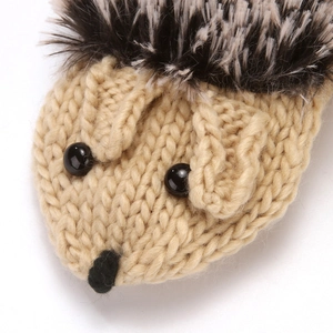 Close-up knit hedgehog mitten detail, cute animal design plush furry top, soft beige texture.