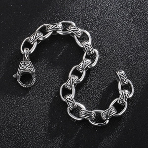 Detailed macro view of vintage stainless steel chain link bracelet with S-pattern engraving