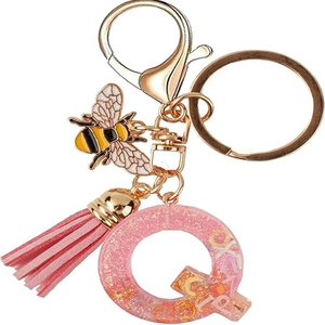 Pink resin letter Q keychain with gold bee charm, tassel and sparkling glitter fill
