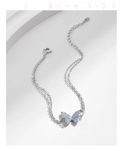 Detail of S925 silver double-layer bracelet with blue butterfly pendant and opal stones