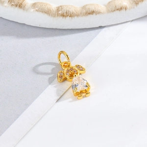 Macro view of a gold girl pendant featuring a large pear-shaped white zircon stone