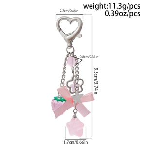 Pink strawberry keychain with bow ribbon, stars and heart clasp shown with dimensions