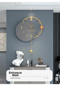 Close-up of modern gold metal ring wall clock with grey dial and geometric pendulum