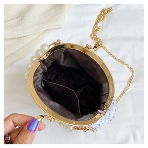 Top view of open pearl evening bag showing dark brown lining and interior storage space