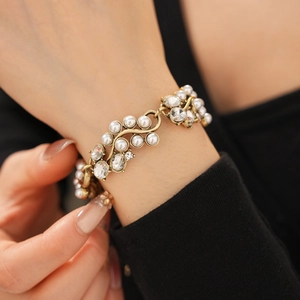 Close-up of vintage flower vine bracelet with white pearls and sparkling crystals on wrist