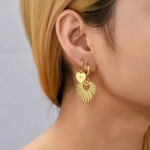 18K gold plated stainless steel heart earrings with diamonds on a female model