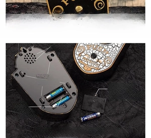 Detail view of the Halloween doorbell back panel showing the battery slot and speaker