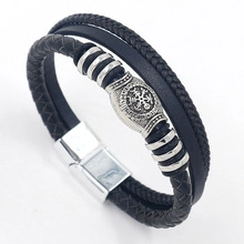 Detail of Viking Vegvisir compass engraving on black woven leather bracelet with magnetic clasp