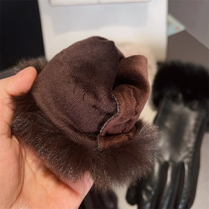 Detail view of winter gloves showing warm faux fur lining and premium PU leather stitching