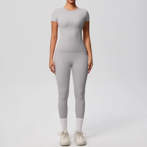 Front full view of tight-fitting grey yoga set with short sleeve t-shirt and high waist leggings