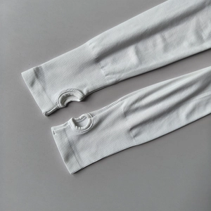 Detail of white yoga top featuring elastic ribbed cuffs and integrated thumbholes