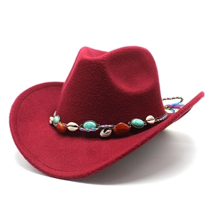 Detail of burgundy jazz hat featuring turquoise beads and ethnic woven decorative band