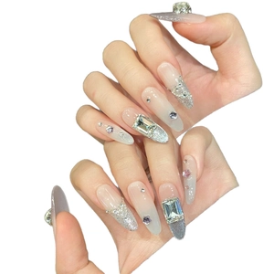 Sparkly white gradient press-on nails with silver glitter and large crystal rhinestones