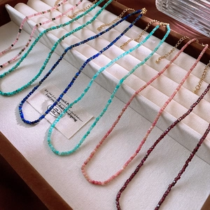 Close-up of assorted colorful natural stone beaded necklaces with gold lobster clasps
