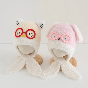 Detailed view of children plush bear earflap hats in beige and pink lamb wool material
