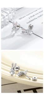 Detailed macro view of rabbit stud earrings featuring pink enamel ears and clear zircon