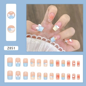 Sweet 3D bow and heart press-on nail set in pastel blue, peach pink, and soft yellow colors