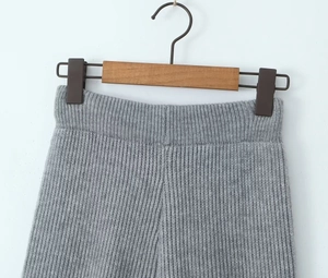 Close-up of elastic high-waist knit pants with fine stitching and soft fabric texture