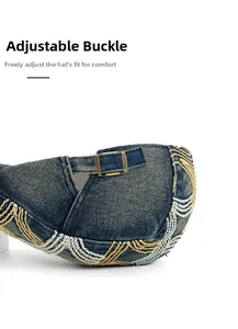 Detail of blue denim beret showing bronze buckle and intricate wave stitching