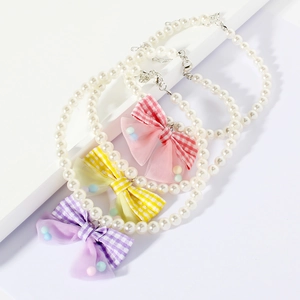 Elegant pet pearl necklace with plaid bows in purple, yellow, and pink colors