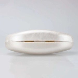 Detail view of the pearl white shell evening bag with elegant golden metal top hinges