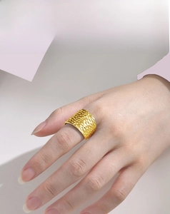 Detail of 18K gold plated stainless steel ring featuring textured hammered surface